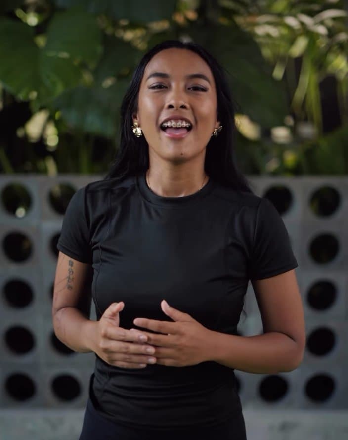 Ain, a Bali-based physical therapist and stretch therapist, outdoors.